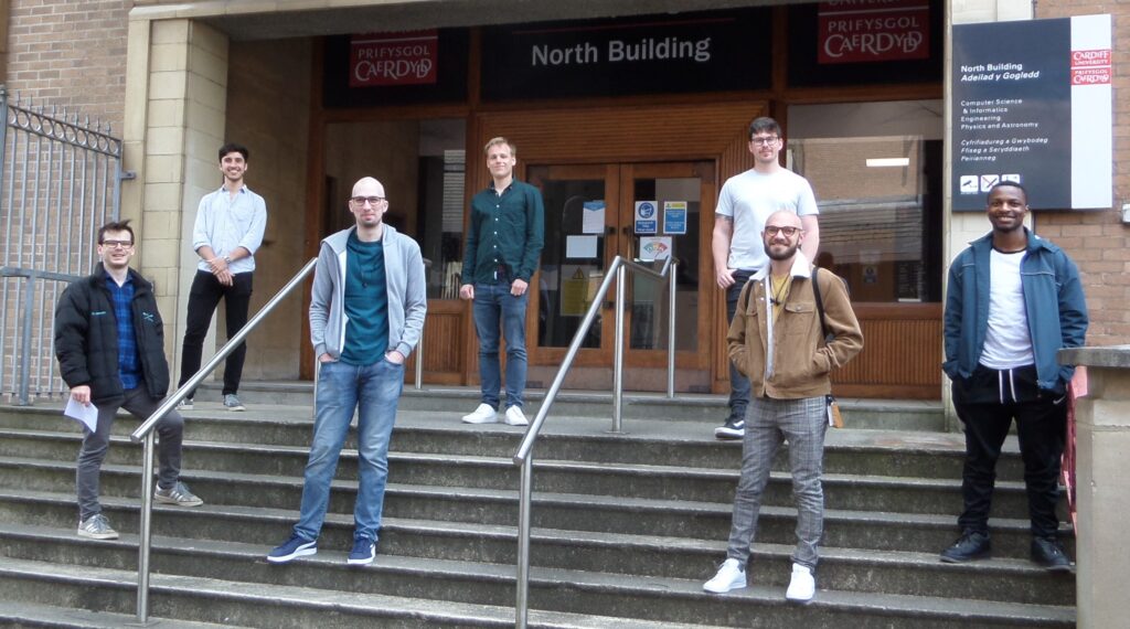 seven of the 14 students in Cohort 2 outside North Building socially distanced